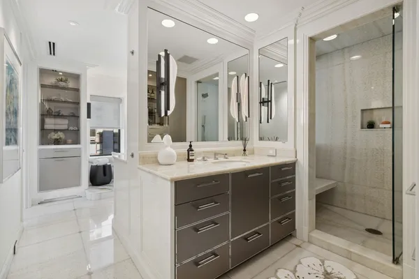 a bathroom with a double vanity sink mirror and shower