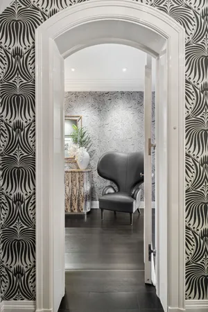 a living room with furniture and a painting on the wall