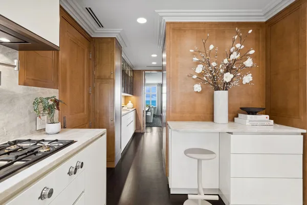 a kitchen with a stove a sink a refrigerator and a dining table