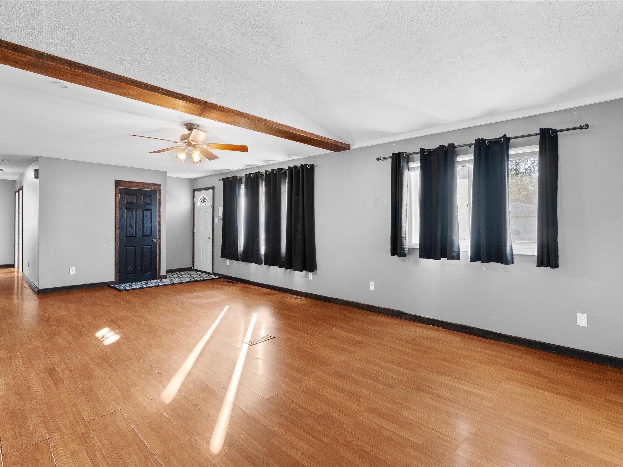 767-1 Heritage Road Valparaiso, IN 46385 - Photo 4 of 20 a view of an empty room with window and wooden floor