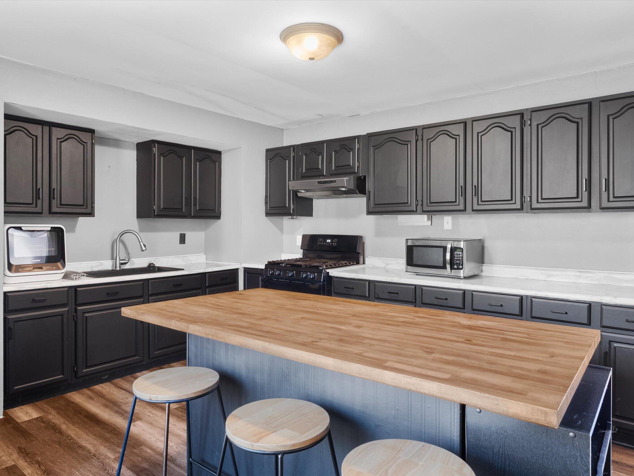 767-1 Heritage Road Valparaiso, IN 46385 - Photo 8 of 20 a kitchen with stainless steel appliances granite countertop a sink dishwasher a stove a refrigerator with grey cabinets and wooden floor