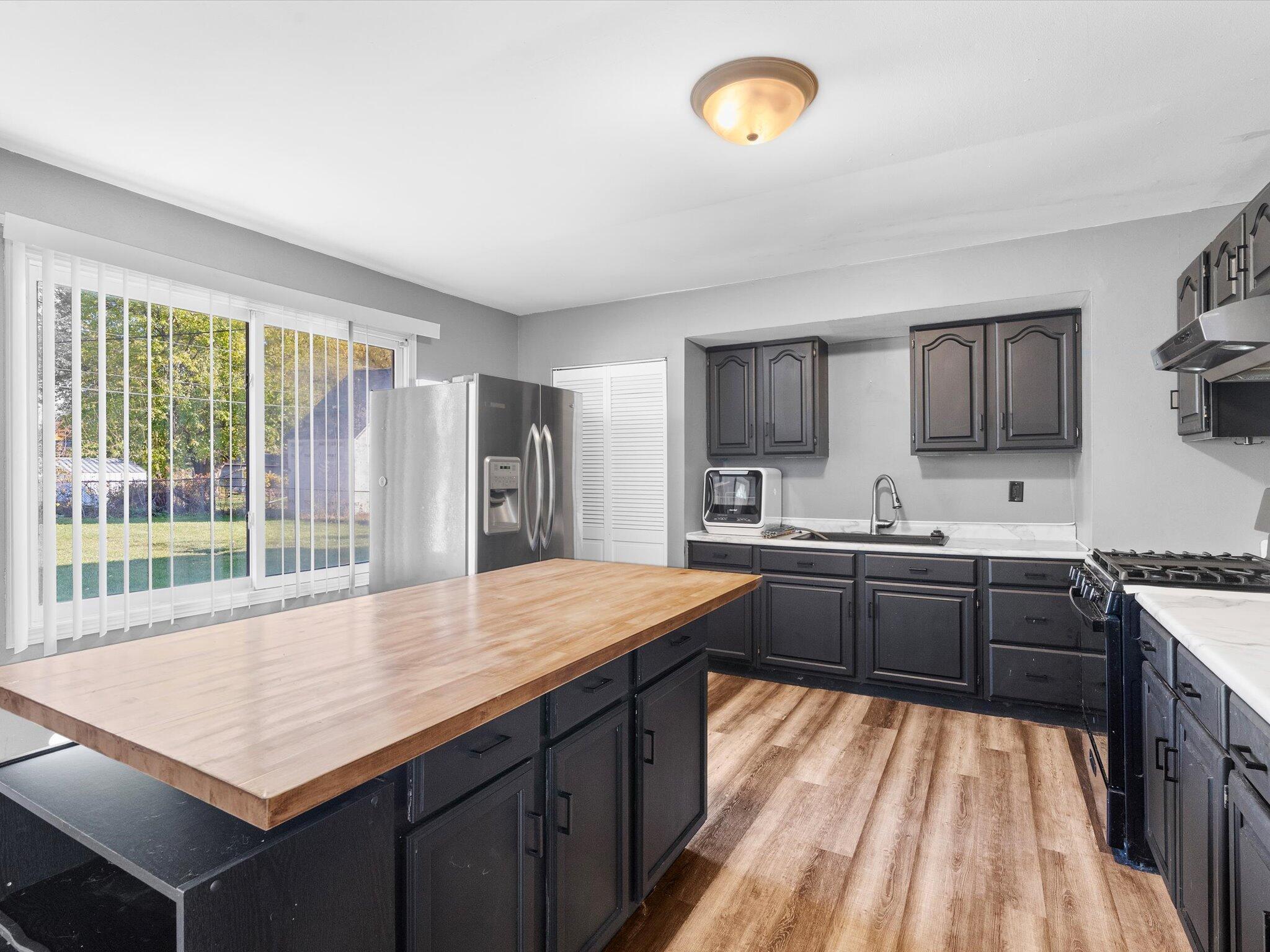 767-1 Heritage Road Valparaiso, IN 46385 - Photo 9 of 20 a kitchen with stainless steel appliances granite countertop a sink stove and refrigerator