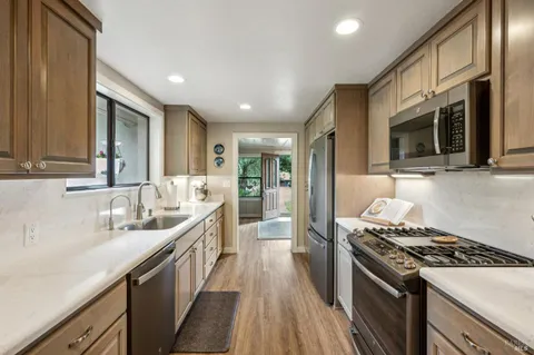 a kitchen with a sink stove and cabinets