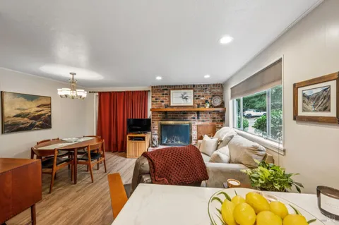 a living room with fireplace furniture and a flat screen tv
