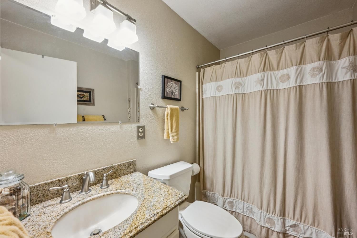 9760 Willow Avenue Cotati, CA 94931 - Photo 22 of 63 a bathroom with a granite countertop sink and a mirror