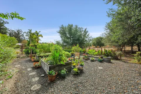 a view of a house with a yard and sitting area