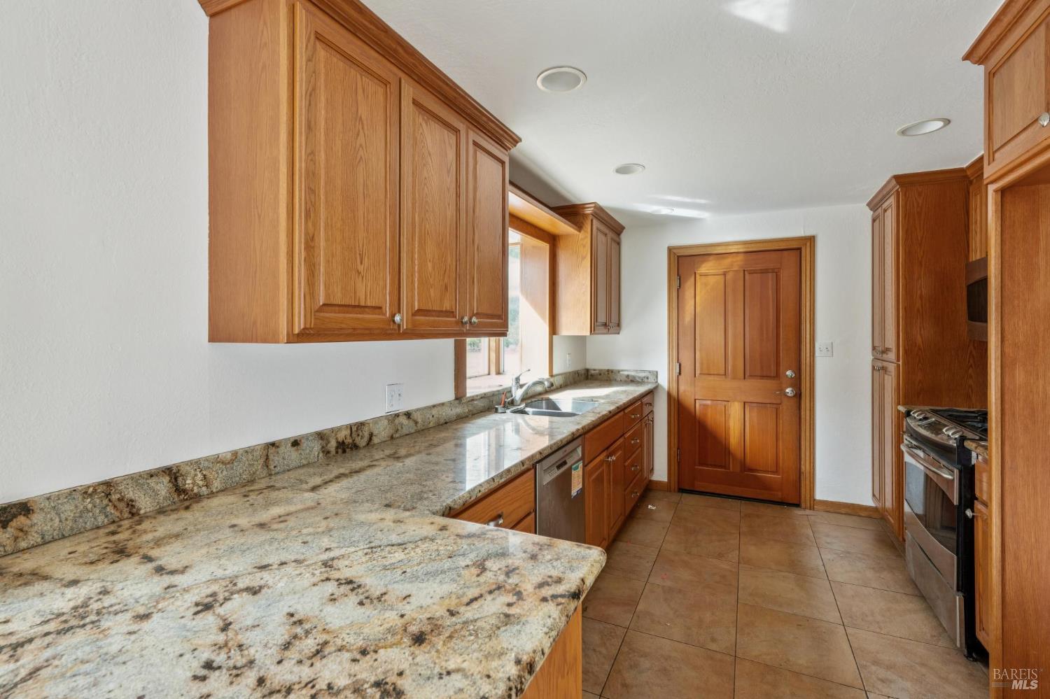 9760 Willow Avenue Cotati, CA 94931 - Photo 41 of 63 a large kitchen with a stove a refrigerator and a sink