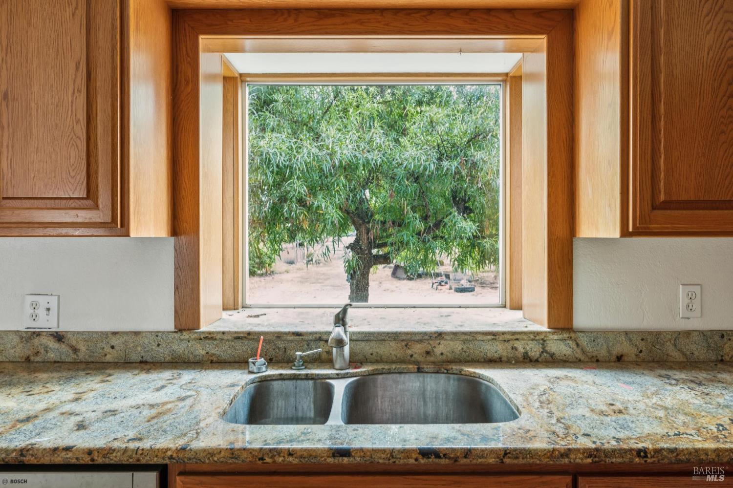 9760 Willow Avenue Cotati, CA 94931 - Photo 42 of 63 a kitchen with granite countertop a sink and a window
