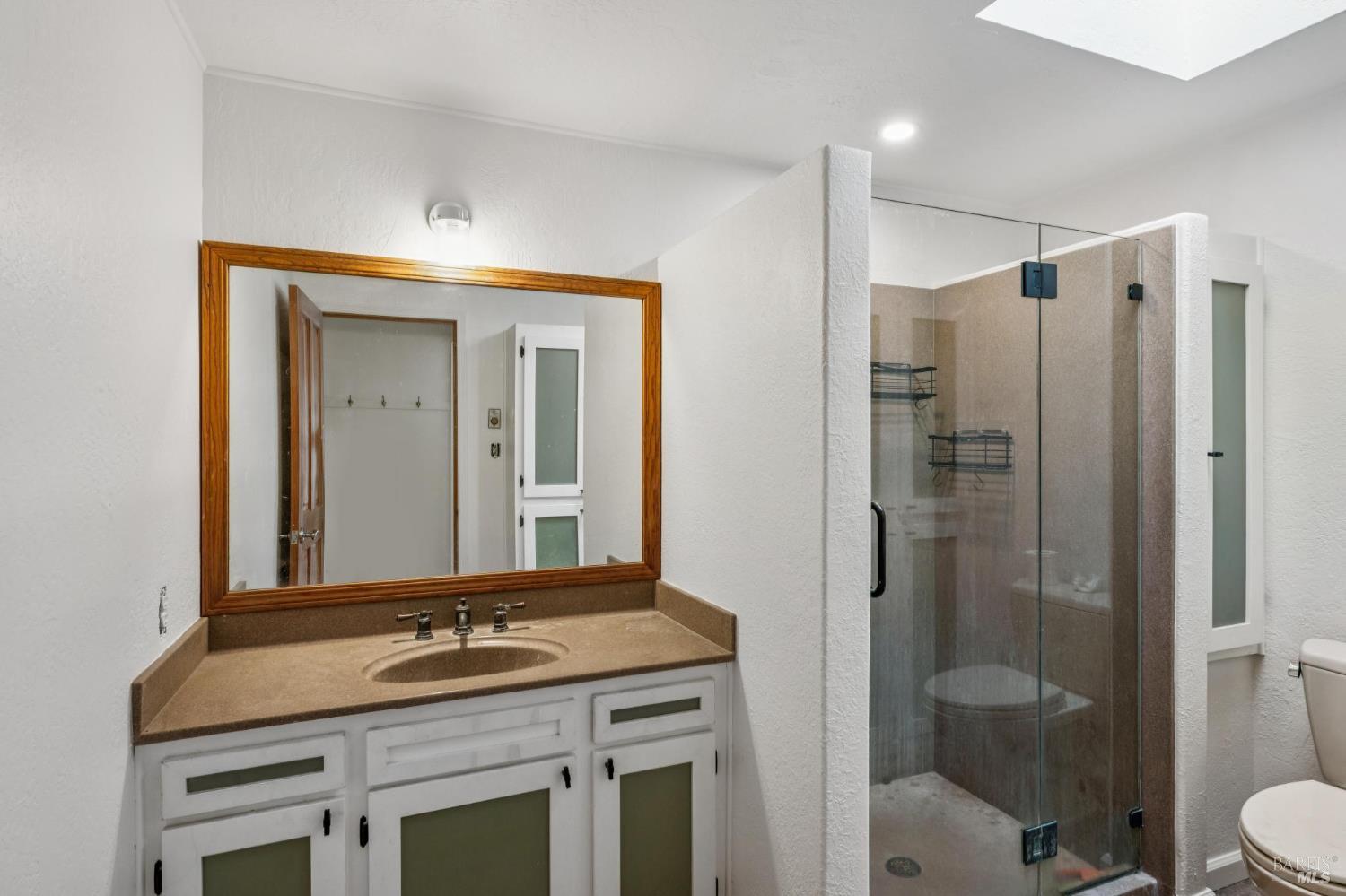 9760 Willow Avenue Cotati, CA 94931 - Photo 46 of 63 a bathroom with a granite countertop sink a toilet and shower