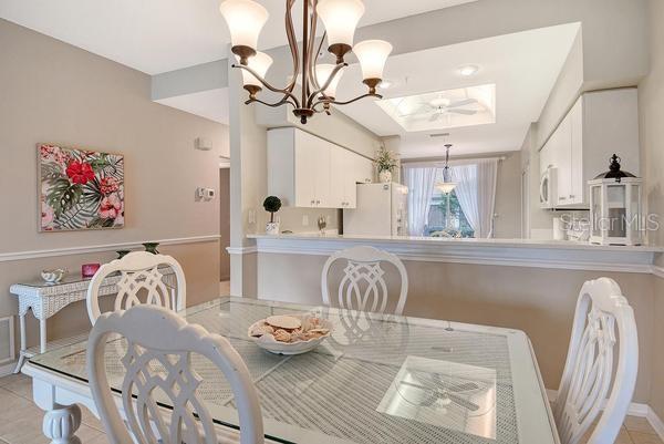 9641 Castle Point Drive, Unit 1215 Sarasota, FL 34238 - Photo 12 of 48 a living room with furniture and wooden floor