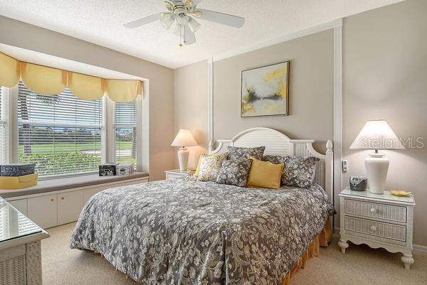 9641 Castle Point Drive, Unit 1215 Sarasota, FL 34238 - Photo 18 of 48 a bedroom with a bed and a night stand