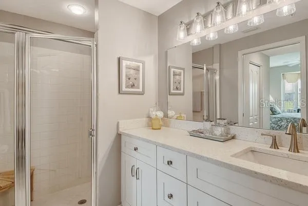a bathroom with double vanity sinks and a mirror