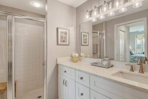 9641 Castle Point Drive, Unit 1215 Sarasota, FL 34238 - Photo 19 of 48 a bathroom with double vanity sinks and a mirror