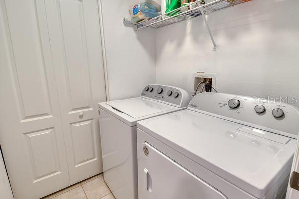 9641 Castle Point Drive, Unit 1215 Sarasota, FL 34238 - Photo 22 of 48 a utility room with dryer and washer