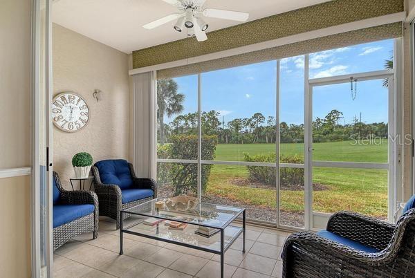 9641 Castle Point Drive, Unit 1215 Sarasota, FL 34238 - Photo 23 of 48 a living room with furniture and a floor to ceiling window