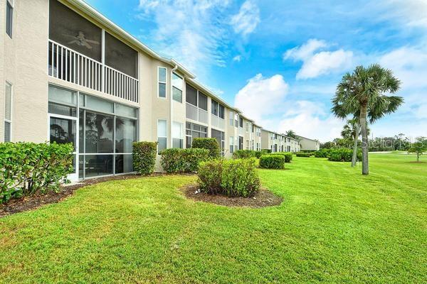 9641 Castle Point Drive, Unit 1215 Sarasota, FL 34238 - Photo 26 of 48 a front view of a house with a yard