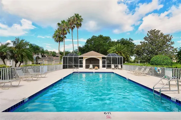 a view of a house with swimming pool and sitting area