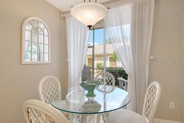9641 Castle Point Drive, Unit 1215 Sarasota, FL 34238 - Photo 4 of 48 a dining room with furniture and window