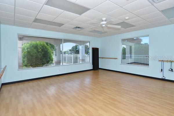 9641 Castle Point Drive, Unit 1215 Sarasota, FL 34238 - Photo 42 of 48 an empty room with wooden floor and windows