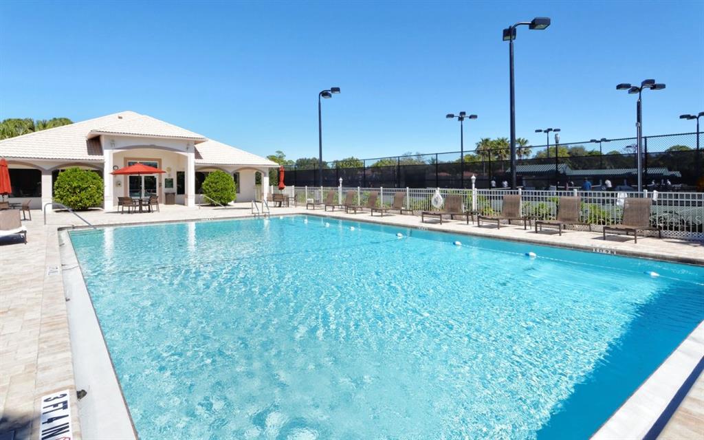 9641 Castle Point Drive, Unit 1215 Sarasota, FL 34238 - Photo 44 of 48 a view of a swimming pool with a yard