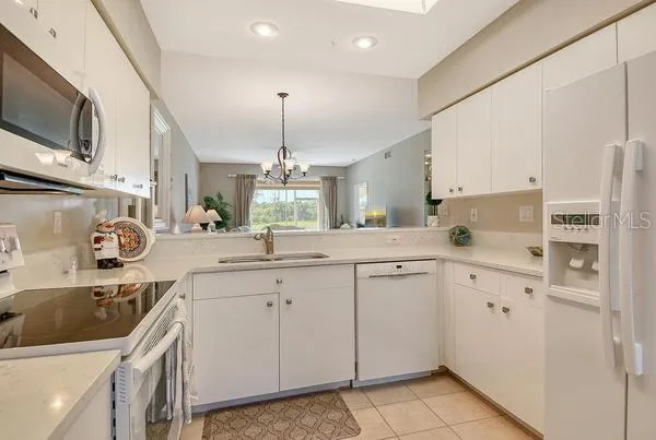 a kitchen with a sink a stove and cabinets