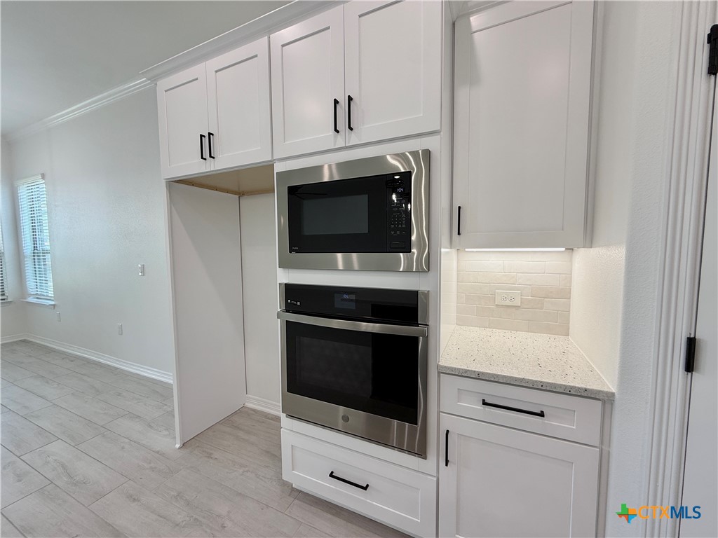 2016 Yarrow Road Temple, TX 76502 - Photo 9 of 30 a kitchen with stainless steel appliances white cabinets and a stove