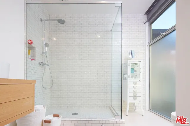 a bathroom with a shower and a sink