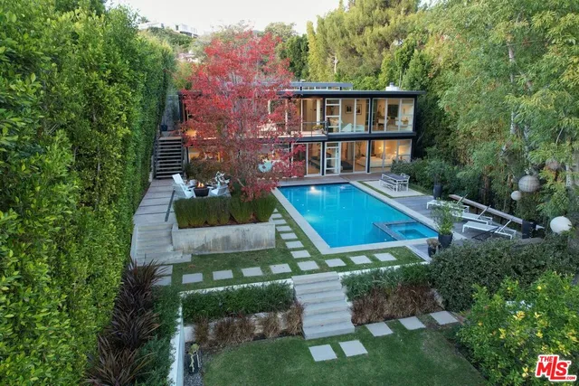 a view of a house with pool and garden