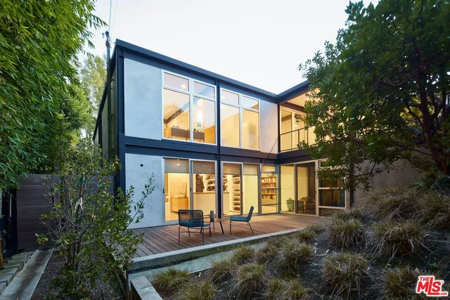 a view of swimming pool with outdoor seating and plants