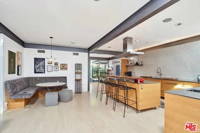 a view of a kitchen with table and chairs