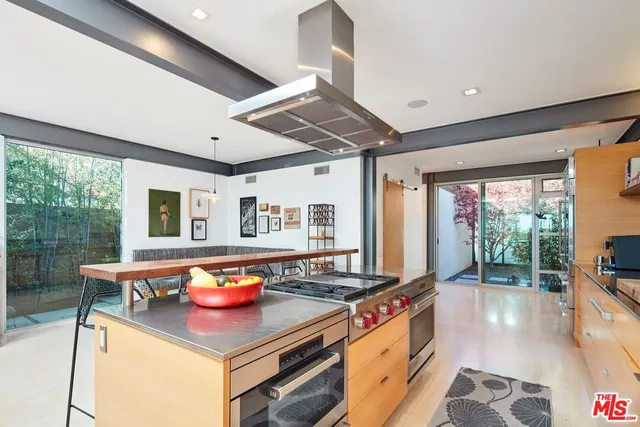 a kitchen with stainless steel appliances granite countertop a stove and a refrigerator