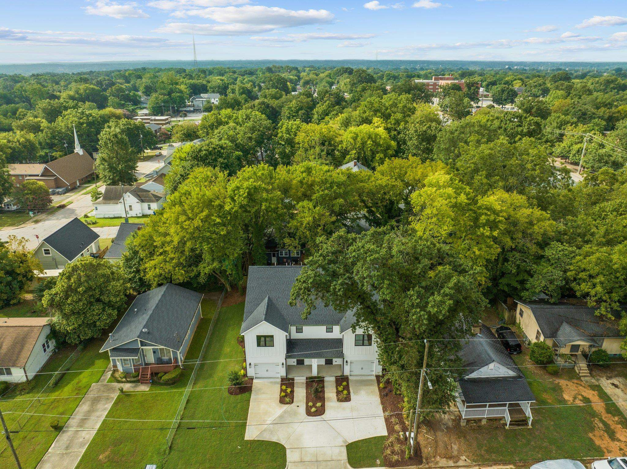 1112 Pender Street Raleigh, NC 27610 - Photo 41 of 56 an aerial view of residential houses with outdoor space and trees
