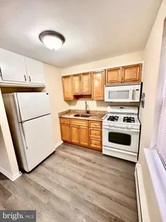 a kitchen with granite countertop a stove and a refrigerator