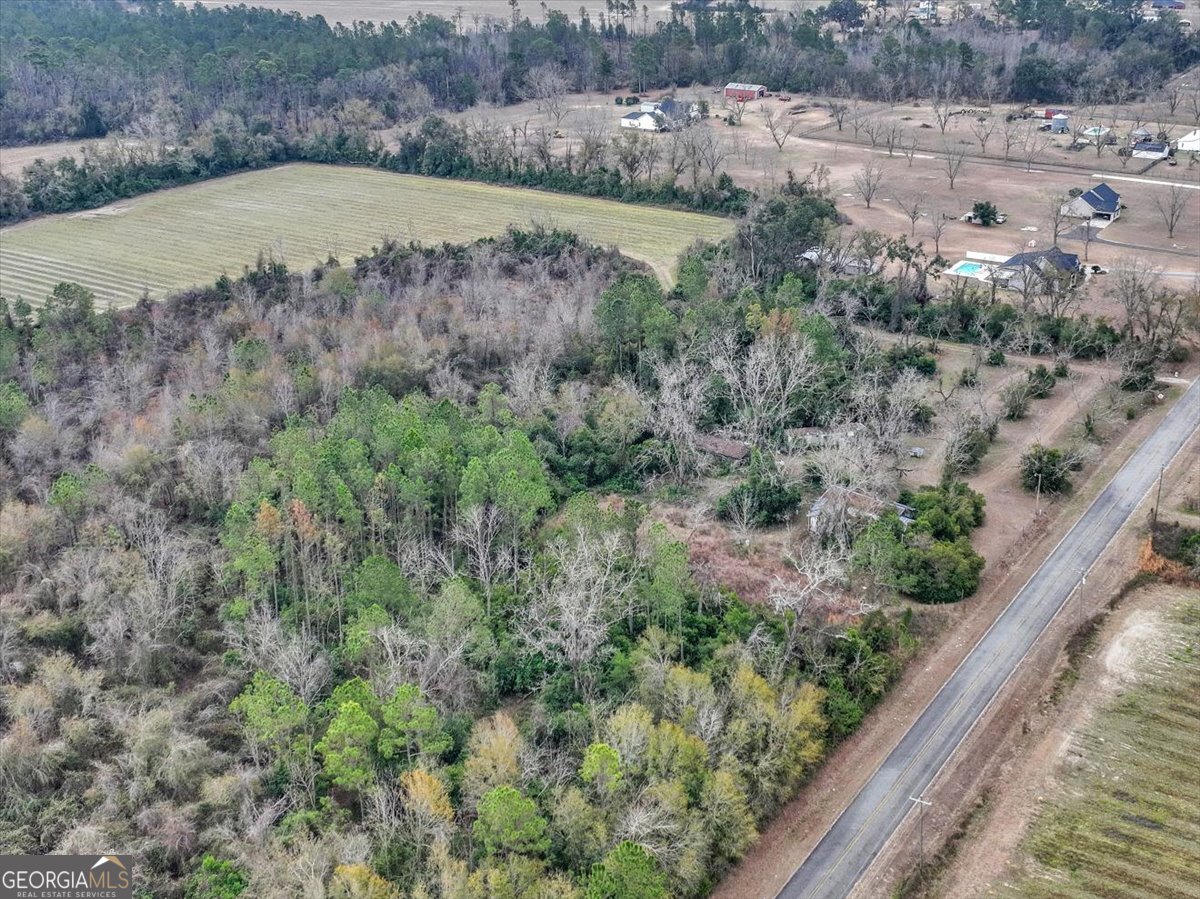 an aerial view of a house with a yard and lake view