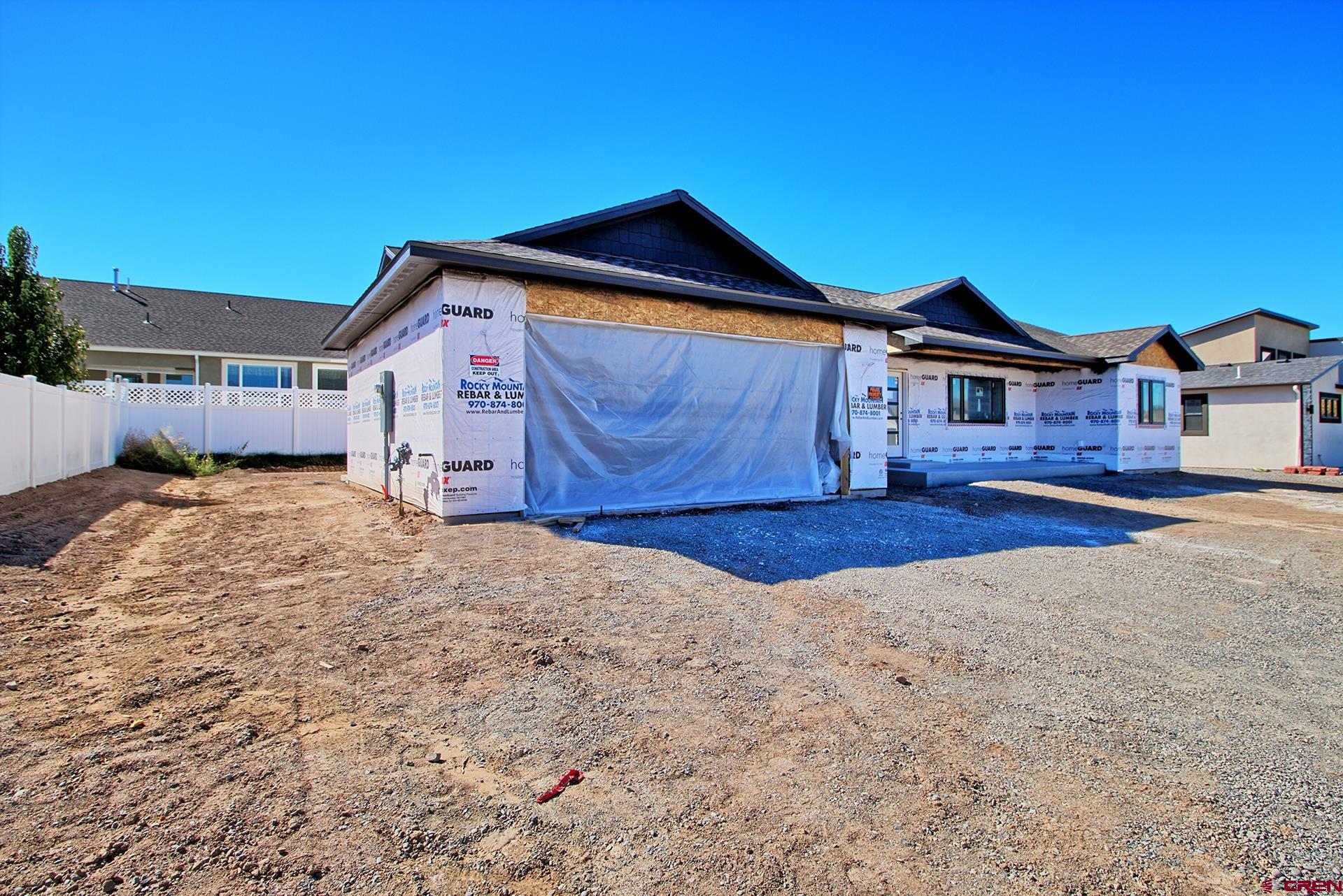 1746 Lynx Street Delta, CO 81416 - Photo 12 of 13 a front view of a house with a yard and garage