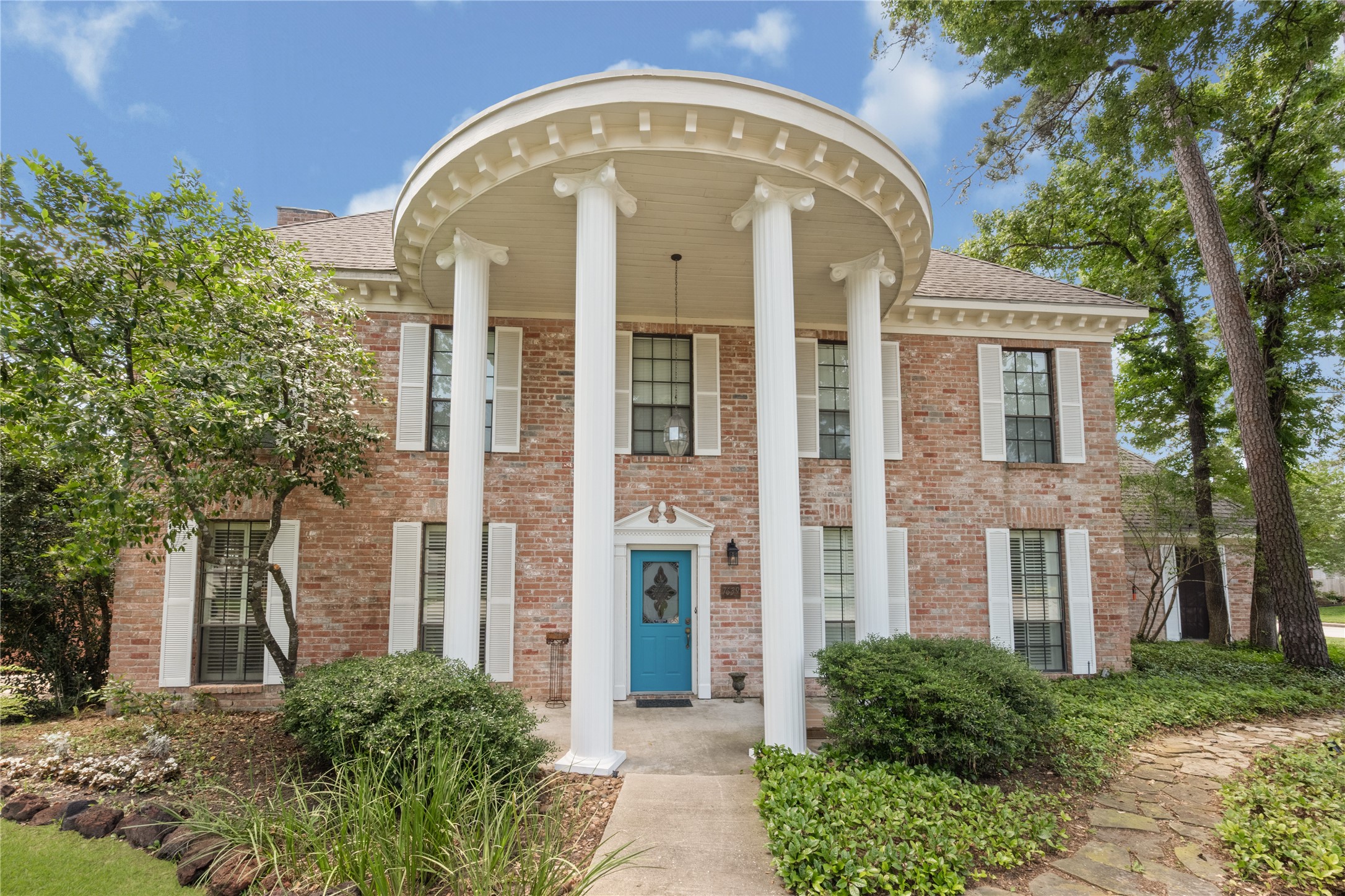 7639 Post Bridge Road Spring, TX 77389 - Photo 4 of 42 front view of a brick house with a large windows