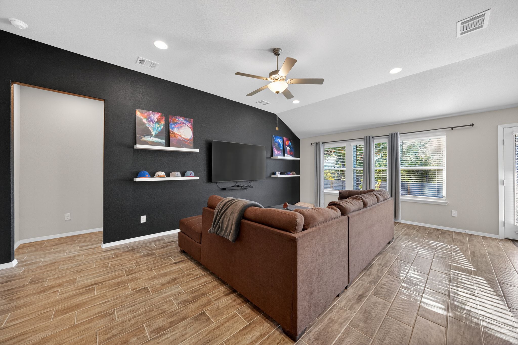 20703 Ridgeview Road Lago Vista, TX 78645 - Photo 12 of 30 a living room with furniture a ceiling fan and a flat screen tv