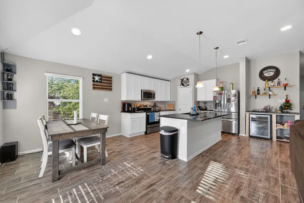 a large kitchen with stainless steel appliances lots of counter space