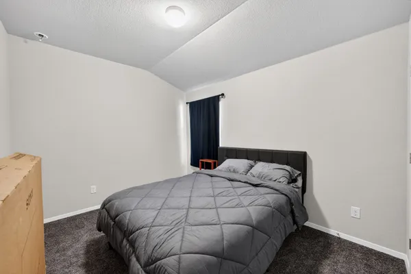 a view of a livingroom with an empty space and a window