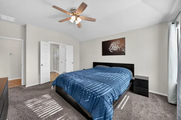 a bedroom with a large bed and a window