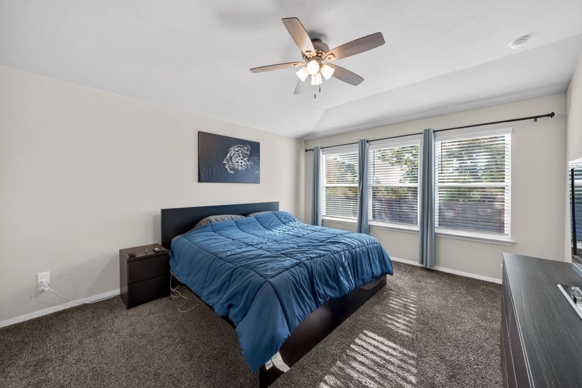20703 Ridgeview Road Lago Vista, TX 78645 - Photo 25 of 30 a bedroom with a large bed and a window