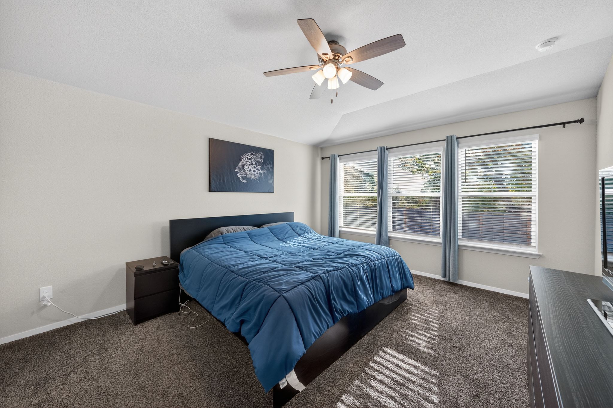 20703 Ridgeview Road Lago Vista, TX 78645 - Photo 25 of 30 a bedroom with a large bed and a window