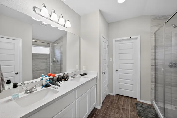 a bathroom with a sink a toilet and shower curtain