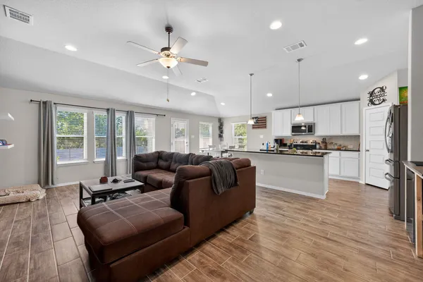 a living room with furniture and a flat screen tv