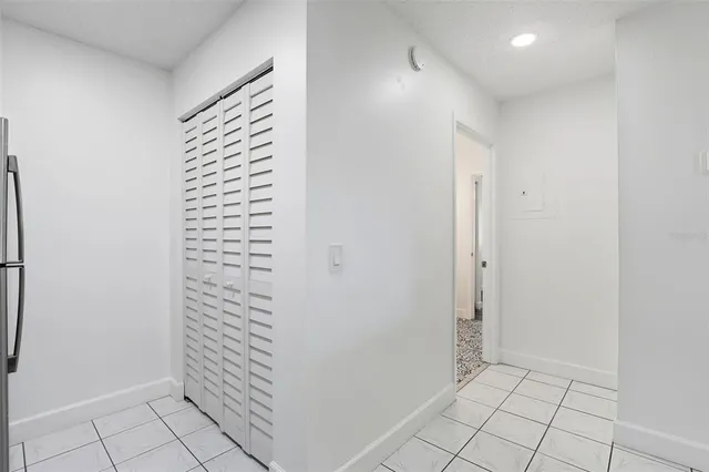 an empty room with a window and a ceiling fan