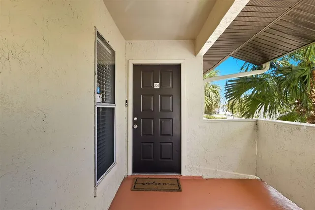 an empty room with fan and windows