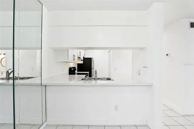 a kitchen with cabinets stainless steel appliances and a counter space