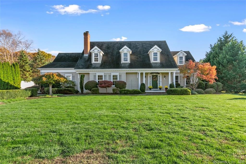 a front view of house with yard and green space