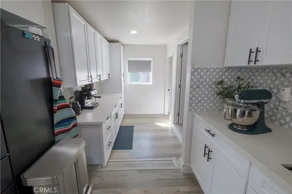 a kitchen with stainless steel appliances a refrigerator and a stove