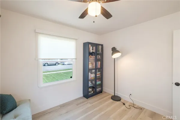 a view of an empty room with window and cabinet